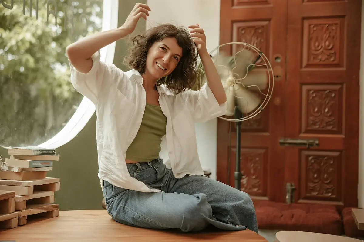 Woman cooling off in front of a fan on a hot day